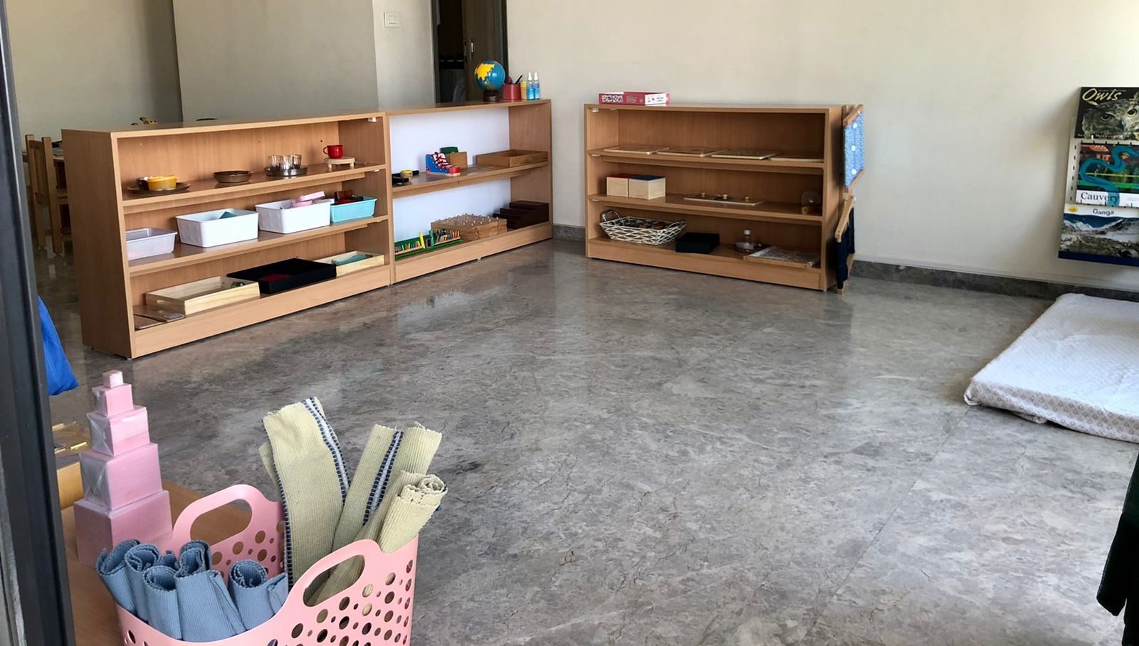 Prepared Montessori classroom with low open shelves and child-accessible materials