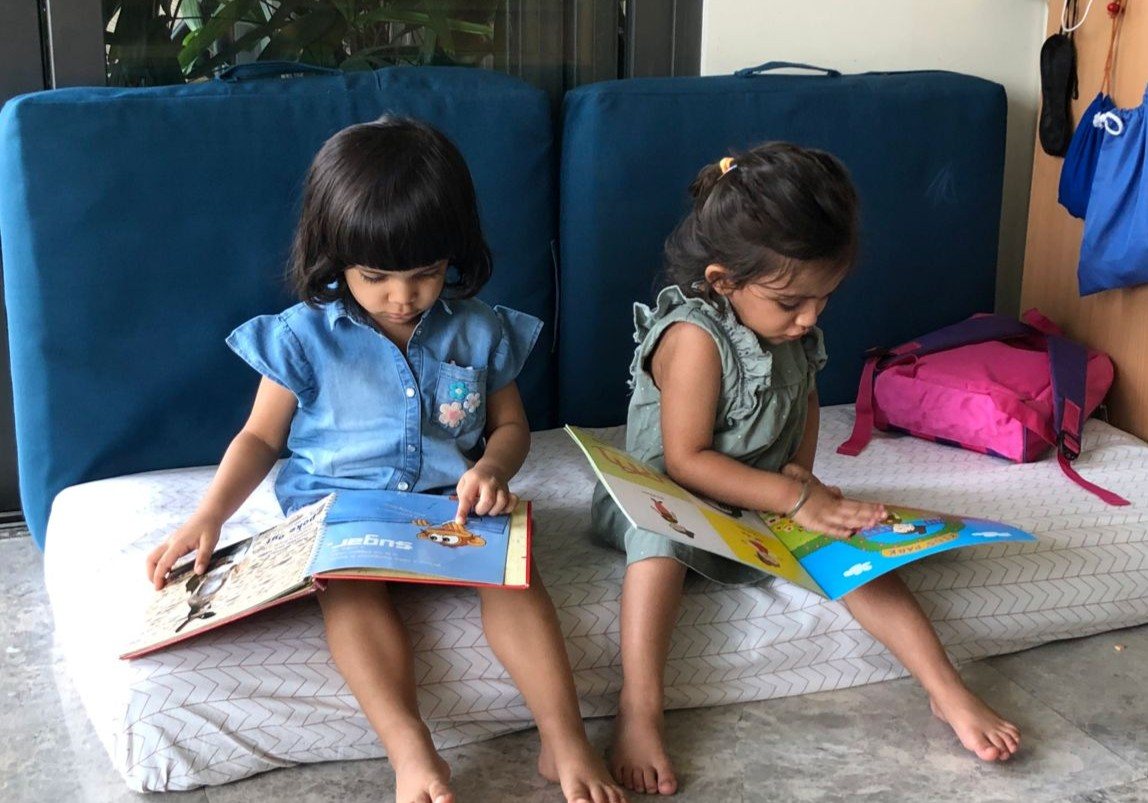 Children reading picture books in the cosy classroom reading corner